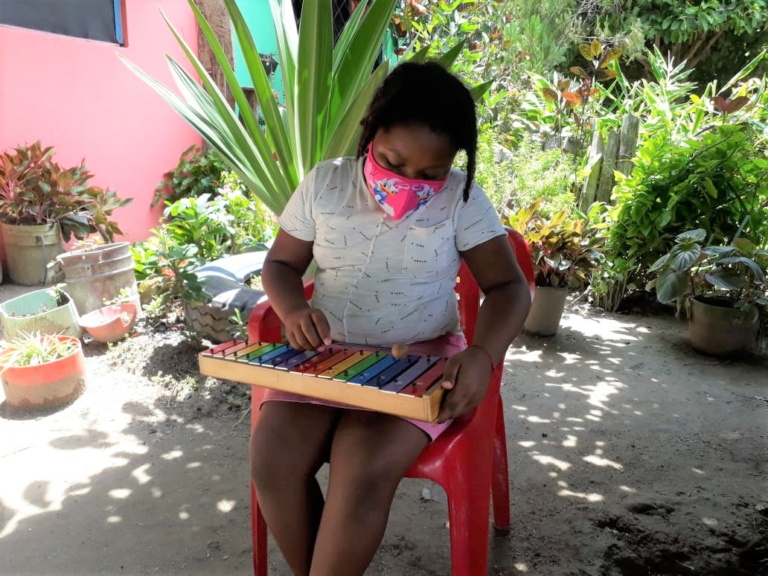 Niños aprendiendo música en la escuela Sueños y Notas de Paz de Fundación Banasan durante la pandemia